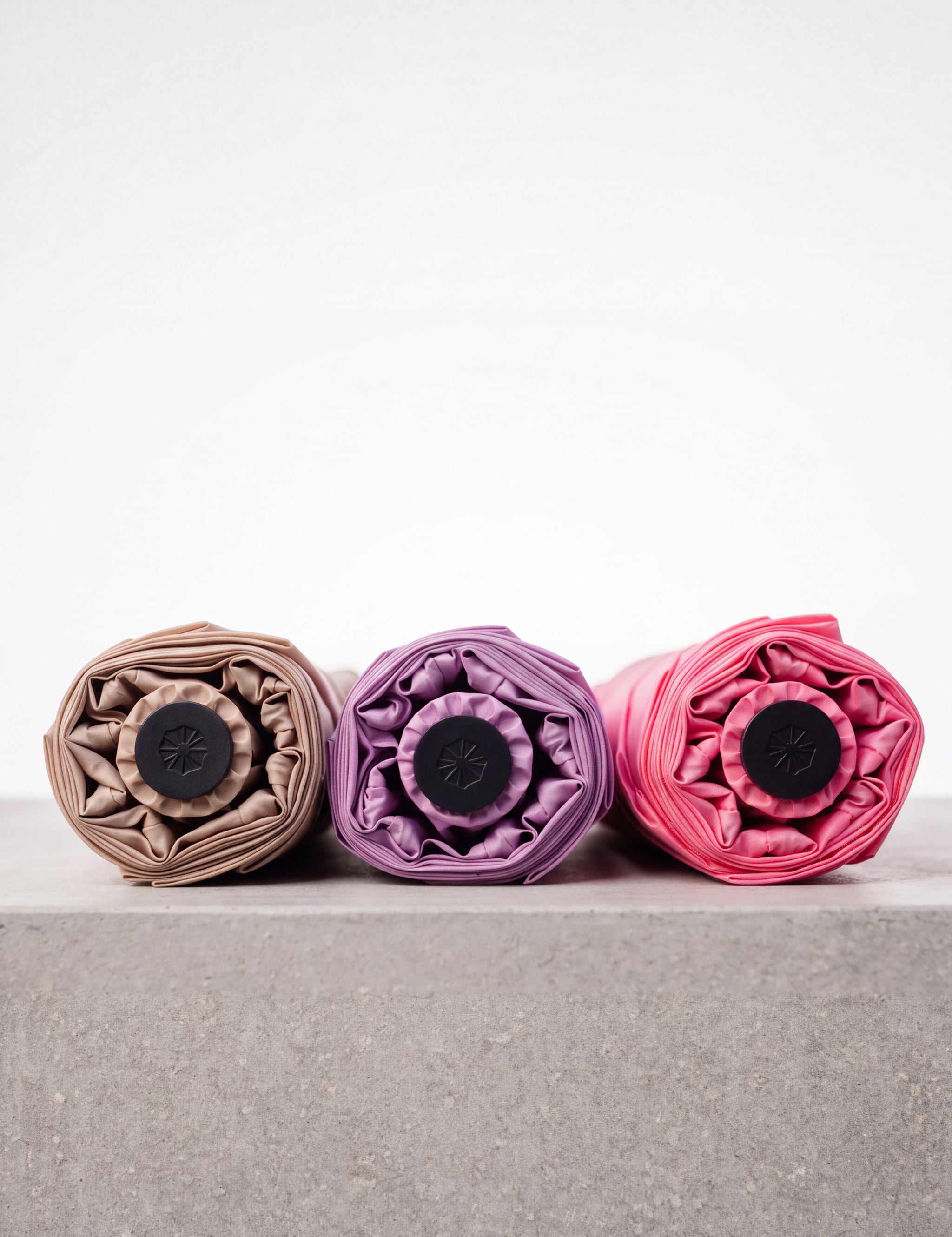 Drei Taschenschirme liegend Sapor Essential in beige, rosa und lila